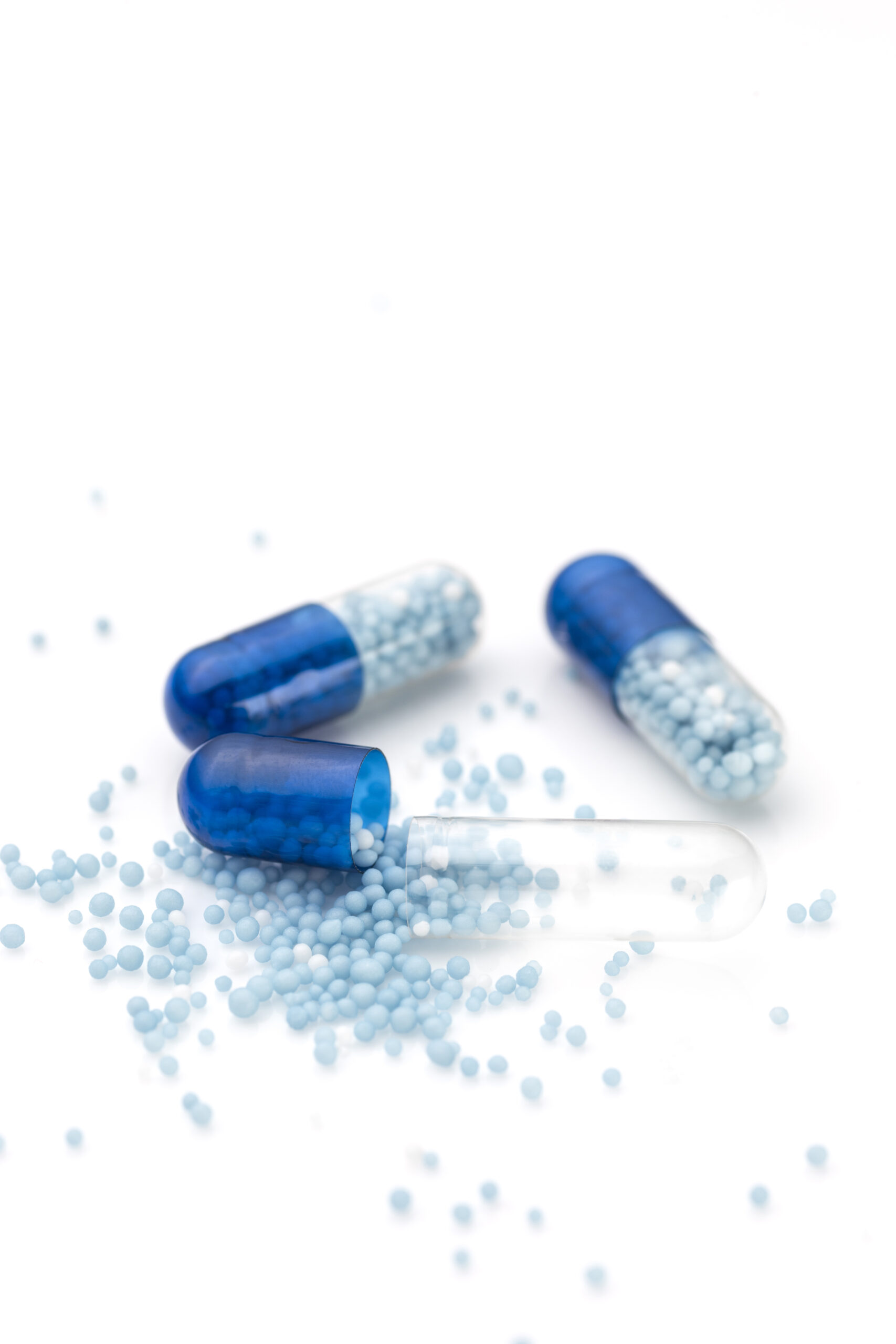 Blue capsules and pills background